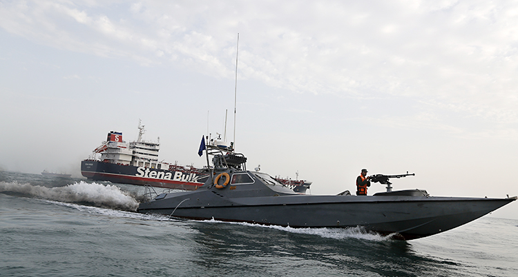 En svart militärbåt syns framför en större båt med texten Stena.