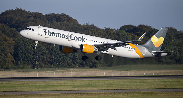 Ett plan lyfter från en flygplats. Det står Thomas Cook på planet.