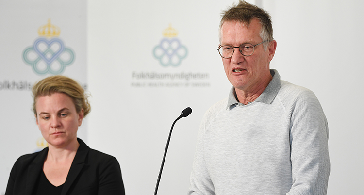 De står vid ett bord med mikrofoner
