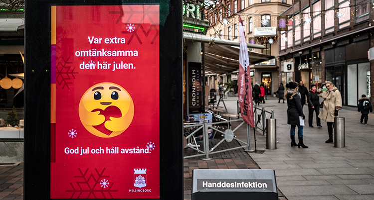 En ganska öde gata i Helsingborg city. En skylt i förgrunden uppmanar folk att vara försiktiga och hålla avstånd.