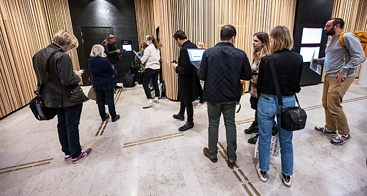Bilden i tagen inne i domstolens hus. Några personer väntar på att få gå in i en sal.