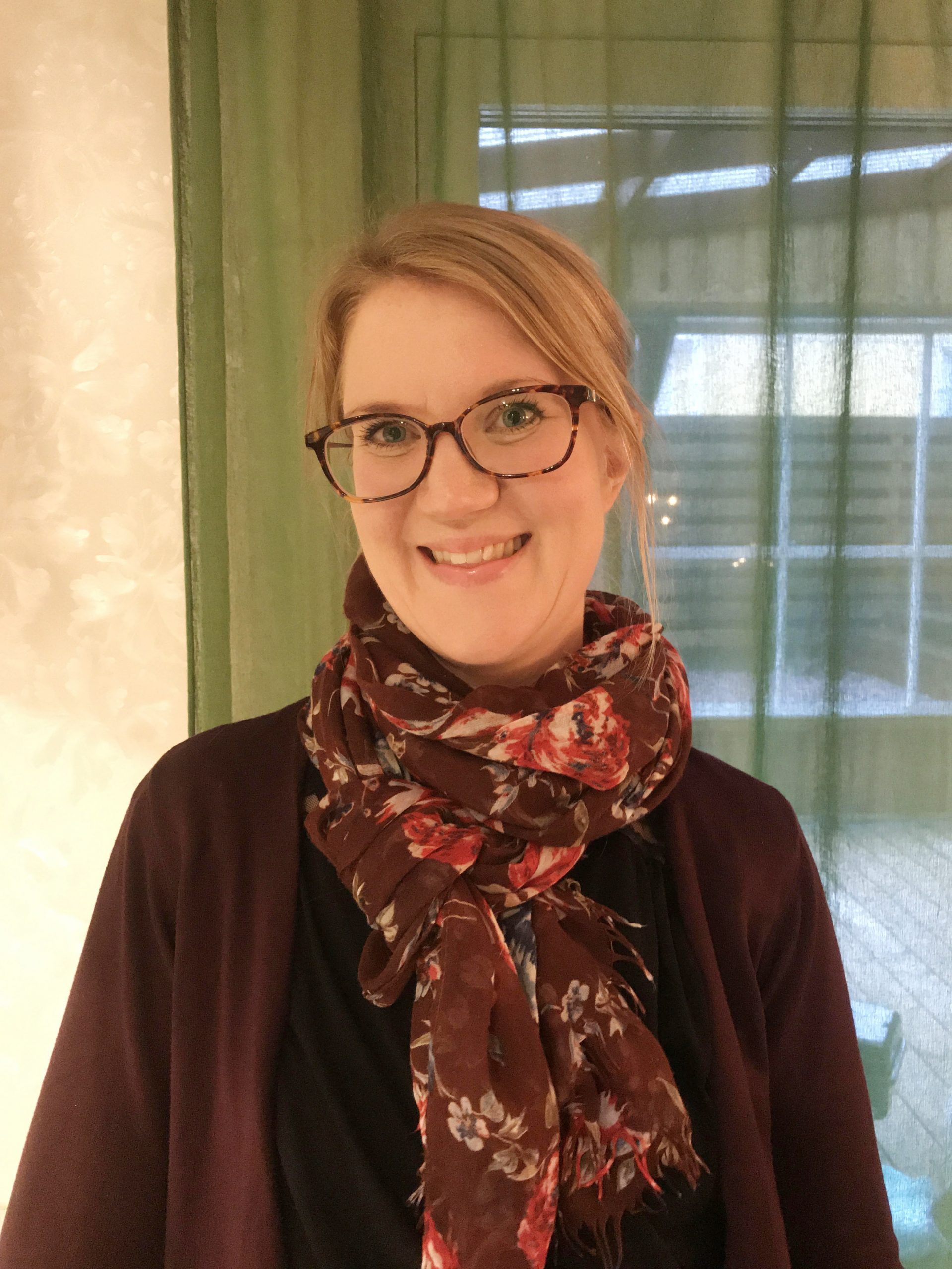 Hon ler och tittar in i kameran.