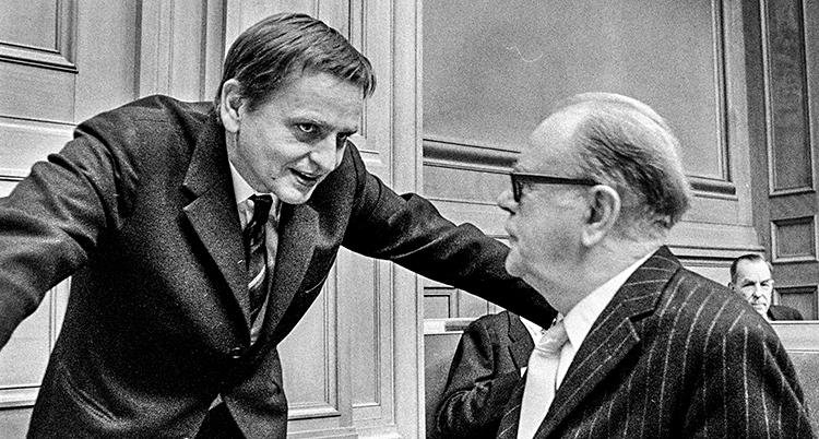 Palme och Erlander pratar med varandra i riksdagshuset. Bilden är svartvit.