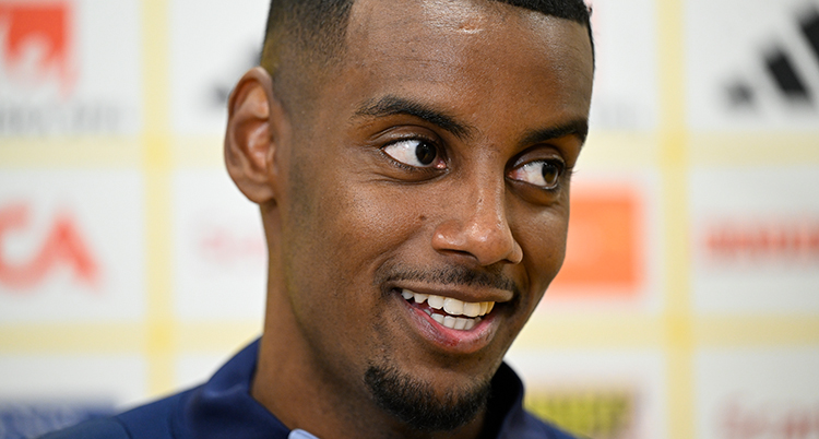 En närbild på Alexander Isak. Han ler och tittar åt sidan.