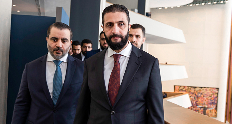 Några män i kostym. Mannen längst fram är Ahmed al-Sharaa.