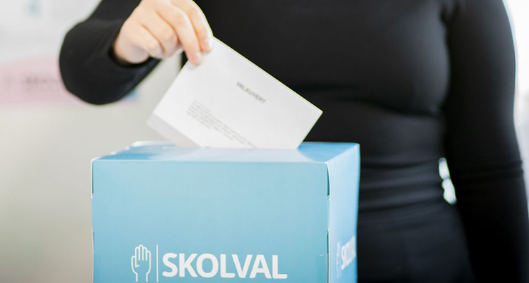 En person lägger en röst i en låda.