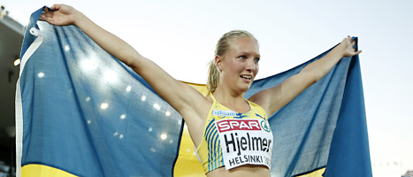 Moa Hjelmner håller upp svenska flaggan för kamerorna efter segern. FOTO: Matt Dunham/SCANPIX