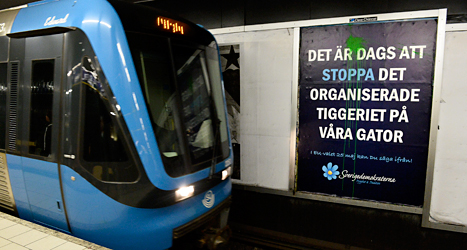 Någon har kastat färg på Sverigedemokraternas affisch i tunnelbanan i Stockholm. Foto: TT
