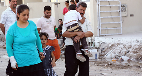 En familj som har flytt från staden Mosul i Irak. Foto: AP/TT