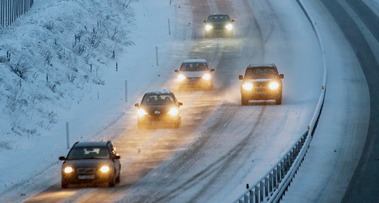 Bilar på en snöig väg.