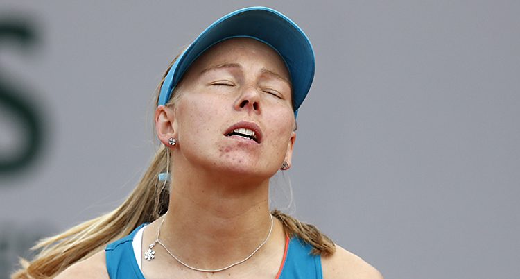 Johanna Larsson blundar efter att hon missat ett slag i en match i tennis.