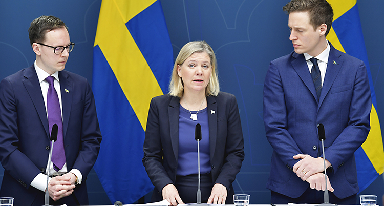 Mats Persson från Liberalerna, finansminister Magdalena Andersson och Emil Källström från Centerpartiet framför två svenska flaggor under en presskonferens i Rosenbad.