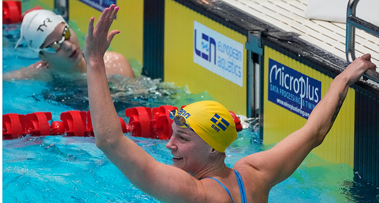 Den svenska simmaren Sarah Sjöström lyfter hand i bassängen.