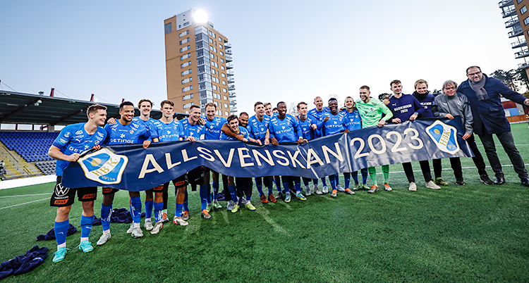 Spelarna i laget Halmstad står bredvid varandra på en fotbollsplan.
