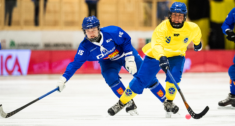 En svensk spelare åker förbi en finsk.