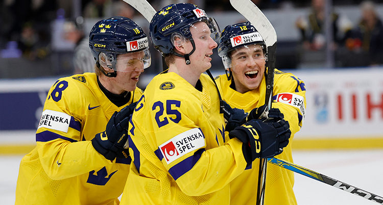 Tre glada ishockeyspelare klappar om varandra.