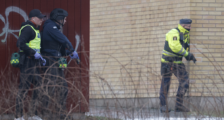 De står bakom ett hörn. De har vapen i händerna.