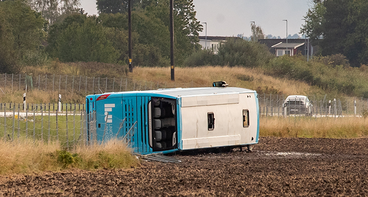 En buss ligger ner vid sidan av vägen.