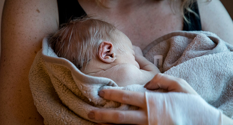 En mamma håller sin bebis.