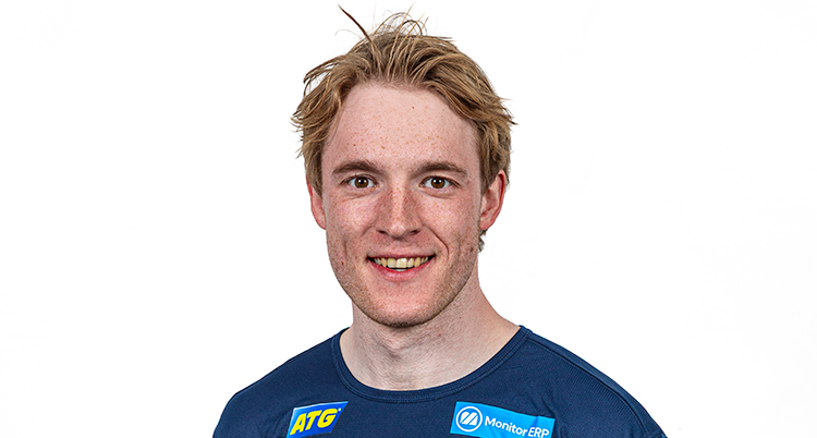 Han ler och tittar in i kameran.