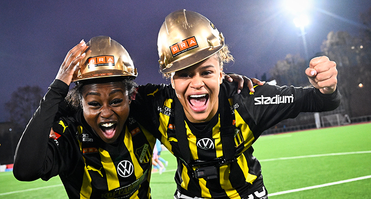 De håller om varandra och skriker av glädje mot fotografen. De har hattar i färg av guld.