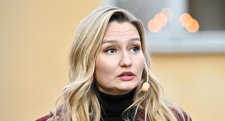En närbild på Ebba Buschs ansikte. Hon har ljust långt hår. Hon tittar åt sidan.