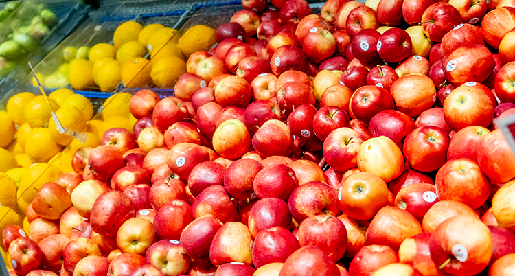 Många äpplen på en hylla i affären.