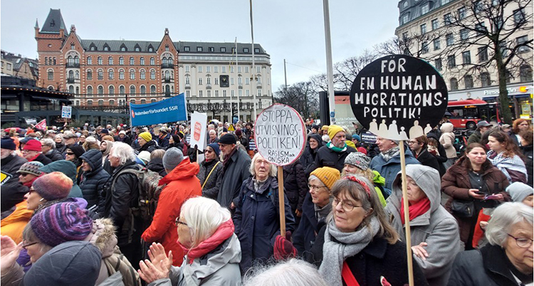 Många människor med skyltar.