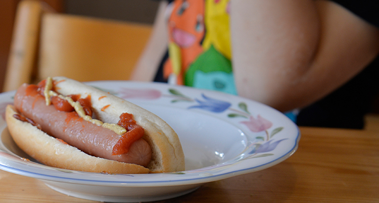 En tallrik med en varmkorv med bröd på.