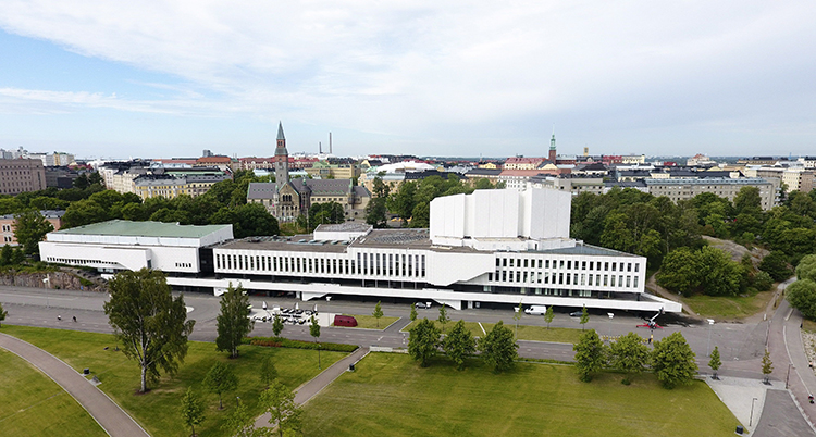 Ett stort vitt hus i en park.