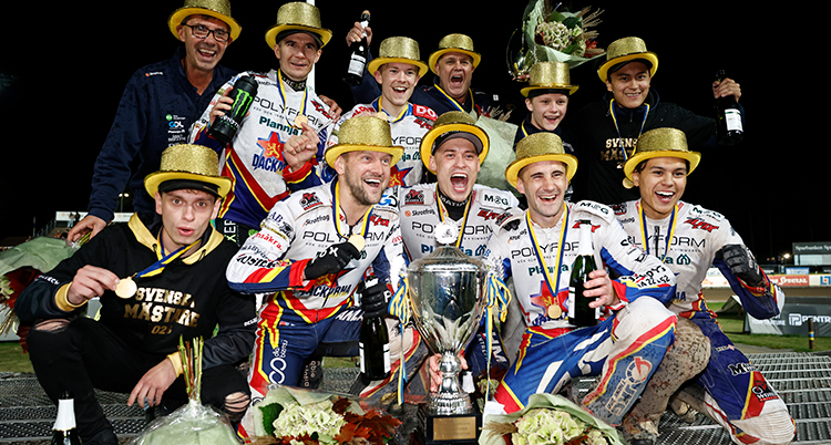 Ungefär tio personer med guldiga hattar. De har en pokal framför sig.