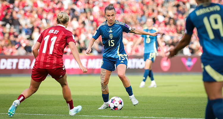 Hon har bollen framför sig under en match.